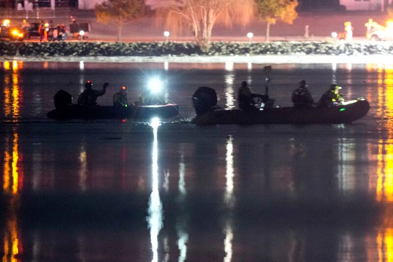 Boats work the scene in the Potomac River near Ronald Reagan Washington National Airport (Alex Brandon/AP)