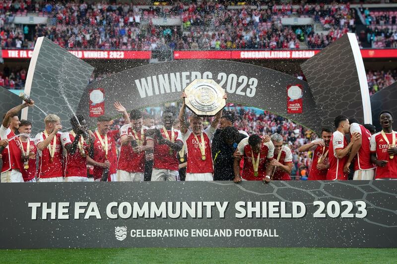 Martin Odegaard (centre) and Arsenal team-mates lift the trophy after the FA Community Shield