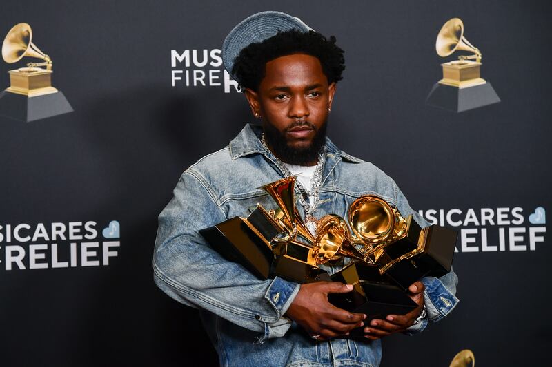 Kendrick Lamar poses in the press room with the award for record of the year, best rap performance, best rap song, best music video and song of the year during the 67th annual Grammy Awards (Richard Shotwell/Invision/AP)