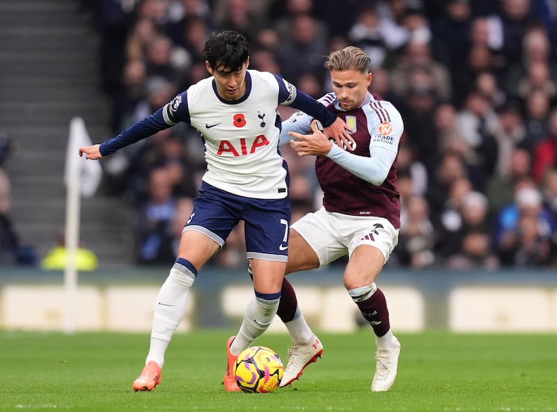 Son Heung-min (left) and Matty Cash battle for the ball