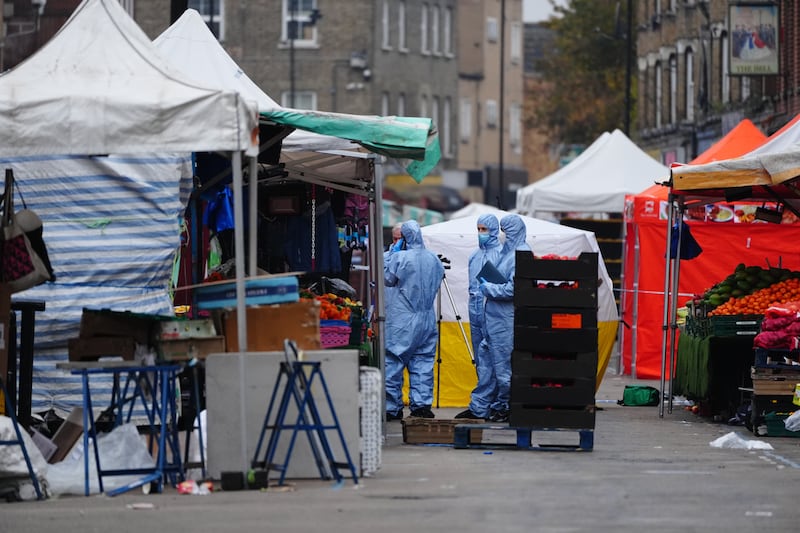 Forensic officers at the scene in East Street, Walworth, south London, following a fatal stabbing