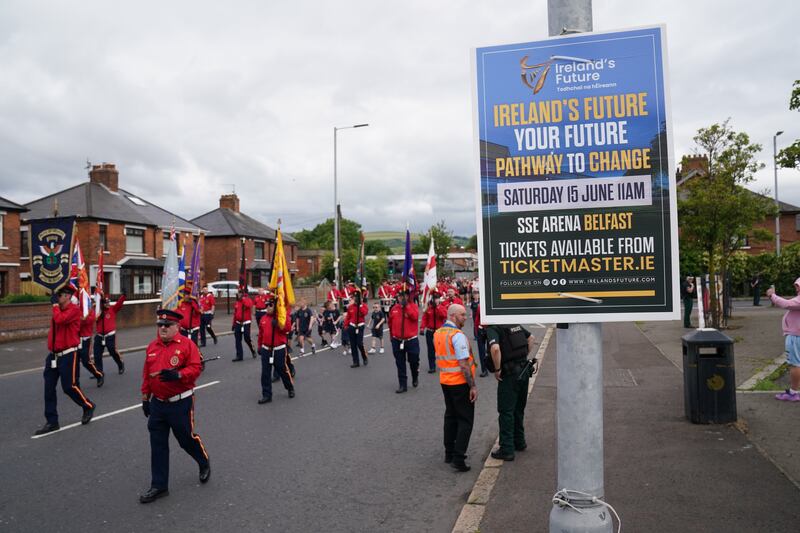 An Orange Order parade passes the Ardoyne shops on the Crumlin Road in Belfast as part of the ‘Twelfth of July’ celebrations earlier this year .