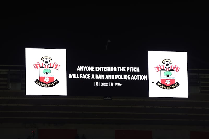 The large stadium screen warning fans to stay in their seats
