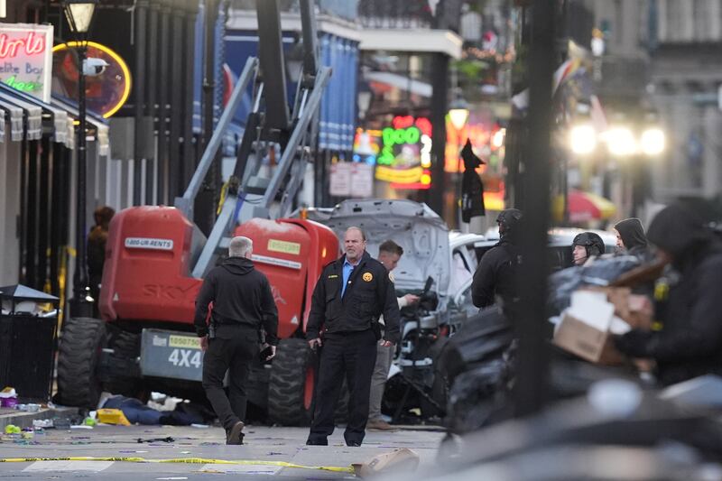 Security personnel investigate the scene on Bourbon Street (Gerald Herbert/AP)