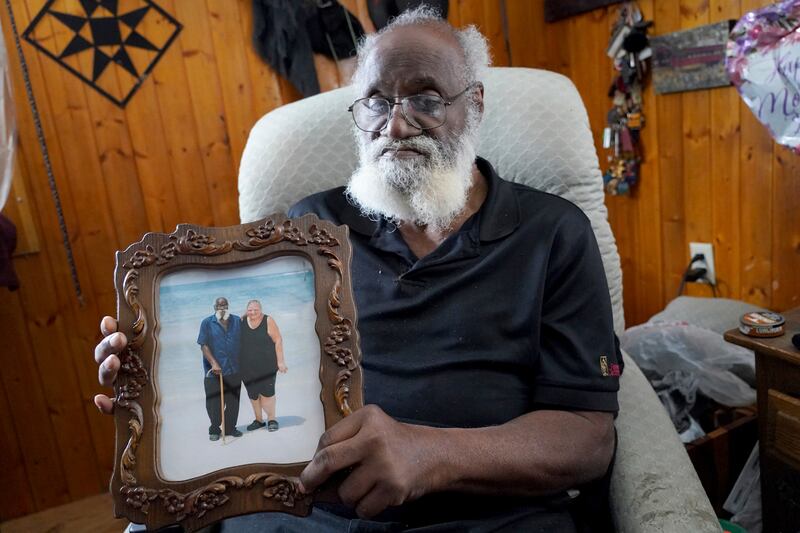 Kenny Pollard shows a holiday photo of himself with his wife Elizabeth (Matt Freed/AP)