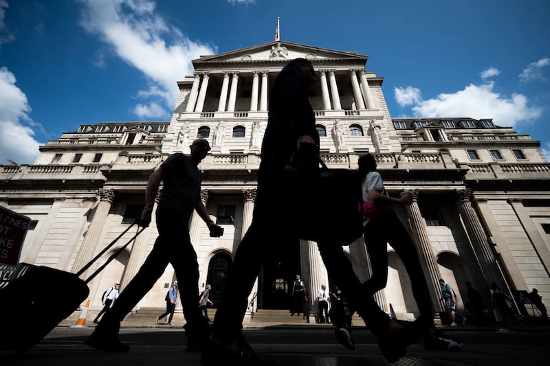 People walk near the Bank of England 