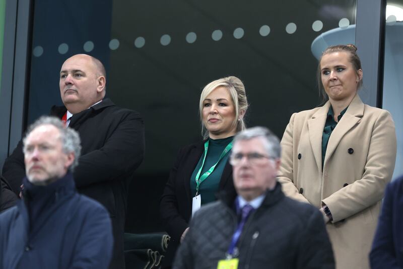 Left to right IFA President Conrad Kirkwood, First Minister Michell O'Neill and Sinn Fein MLA Aisling Reilly stand for the anthems