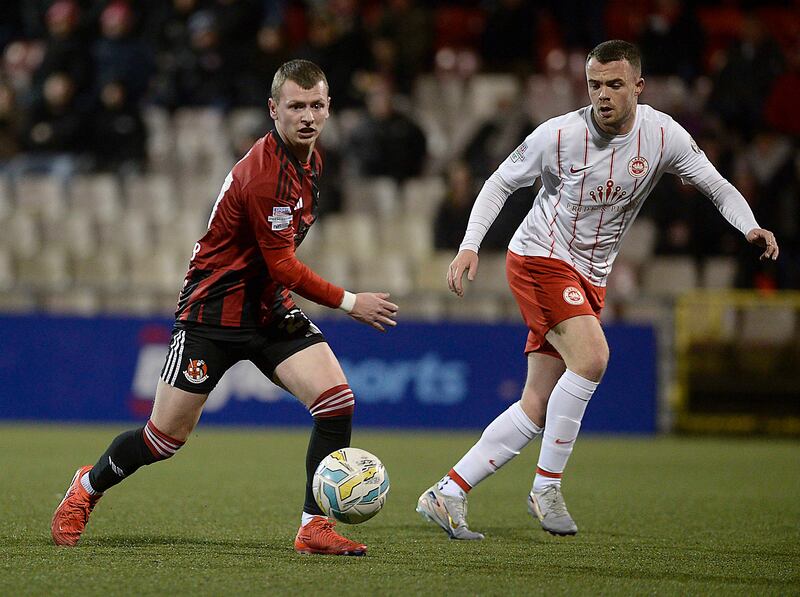 Crusaders' Stewart Nixon and Larne's Christopher Gallagher in action during Tuesday nights match at Seaview in Belfast