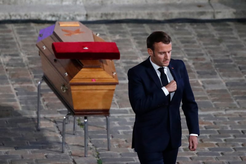 French President Emmanuel Macron leaves after paying his respects by the coffin of slain teacher Samuel Paty (Francois Mori/AP)