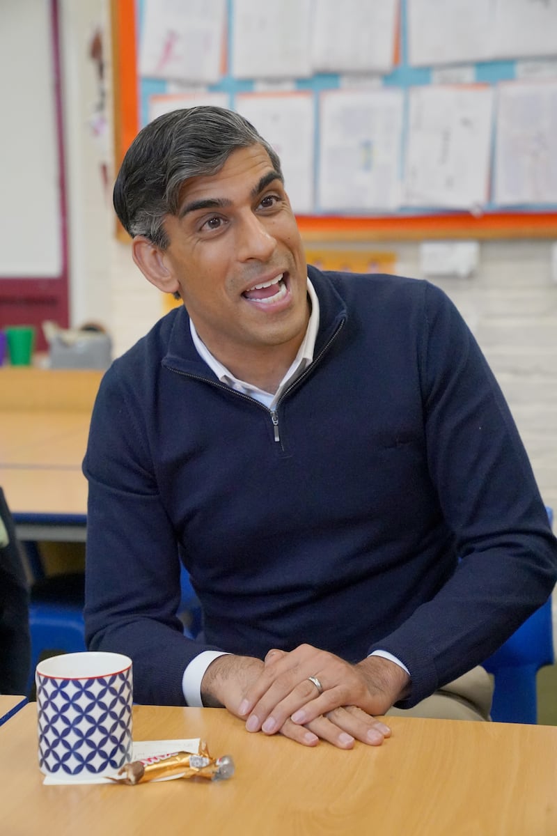 Prime Minister Rishi Sunak speaks to members of the media during a huddle while visiting Braishfield Primary School in Romsey