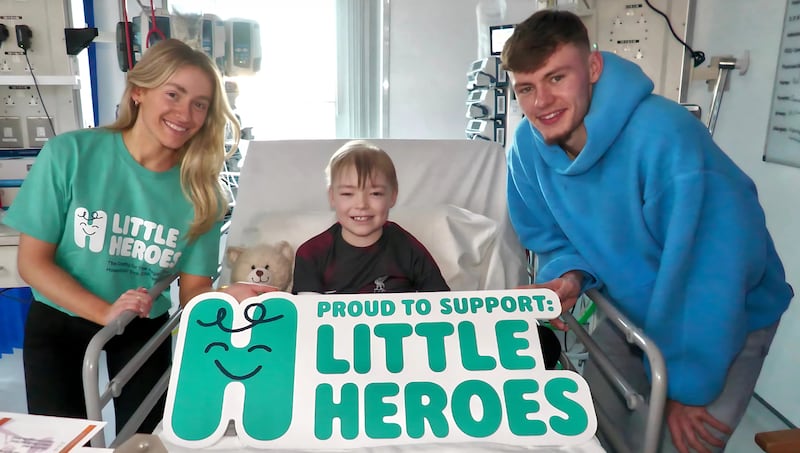 Cliona Thompson, marketing officer at Little Heroes; Jamie Harkness, aged 10; and Conor Bradley, Liverpool FC and Northern Ireland footballer and Little Heroes ambassador, celebrating the launch of Little Heroes at the Royal Belfast Hospital for Sick Children on Tuesday November 19th. (No photographer byline provided)