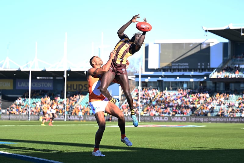 LAUNCESTON, AUSTRALIA - JUNE 08: Changkuoth Jiath of the Hawks and Callum M. Brown of the Giants compete for the ball during the round 13 AFL match between Hawthorn Hawks and GWS GIANTS at University of Tasmania Stadium, on June 08, 2024, in Launceston, Australia. (Photo by Steve Bell/Getty Images)