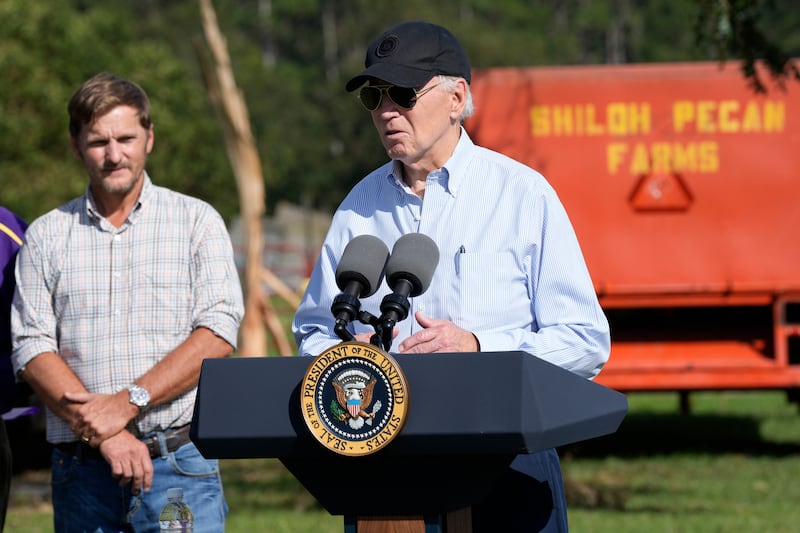 President Joe Biden speaks at Shiloh Pecan Farm as property manager Buck Paulk looks on in Ray City, Georgia as part of Mr Biden’s trip to see areas impacted by Hurricane Helene (Susan Walsh/AP)