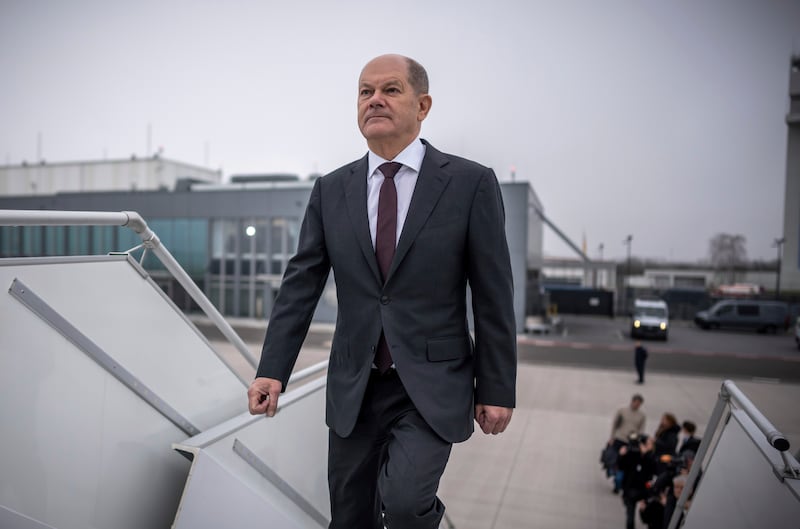 German Chancellor Olaf Scholz boards a plane at Berlin Brandenburg Airport to fly to the US for a meeting with President Joe Biden (Michael Kappeler/dpa via AP)