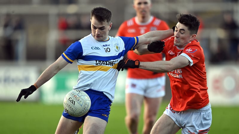 Ruairi Canavan gets his shot away under pressure from Clann Eireann's Conan O'Carroll. Picture; Oliver McVeigh