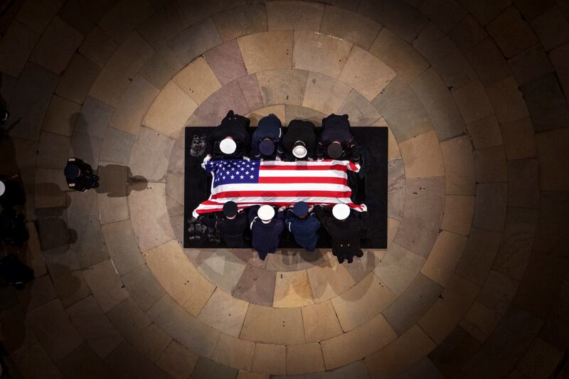 The flag-draped casket of former President Jimmy Carter lies in state at the rotunda of the US Capitol (Andrew Harnik/Pool via AP)