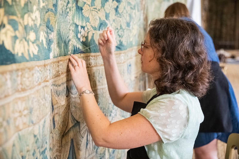 Staff make final adjustments to the tapestries at Hardwick Hall, Derbyshire.