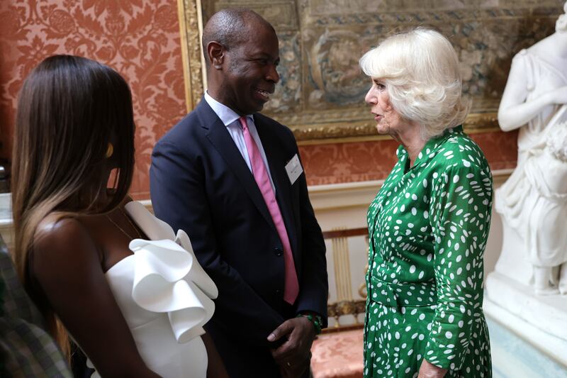 Queen Camilla speaks with Clive Myrie and June Sarpong during a reception at Buckingham Palace in London to celebrate the Windrush Generation and mark the 75th anniversary of the arrival of the HMT Empire Windrush in 2023