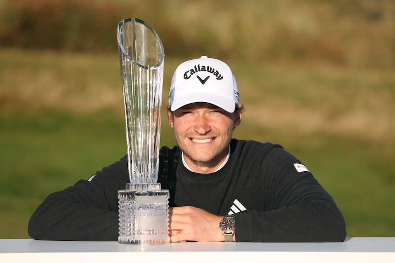 Denmark’s Rasmus Hojgaard poses with the Amgen Irish Open trophy following his win at Royal County Down