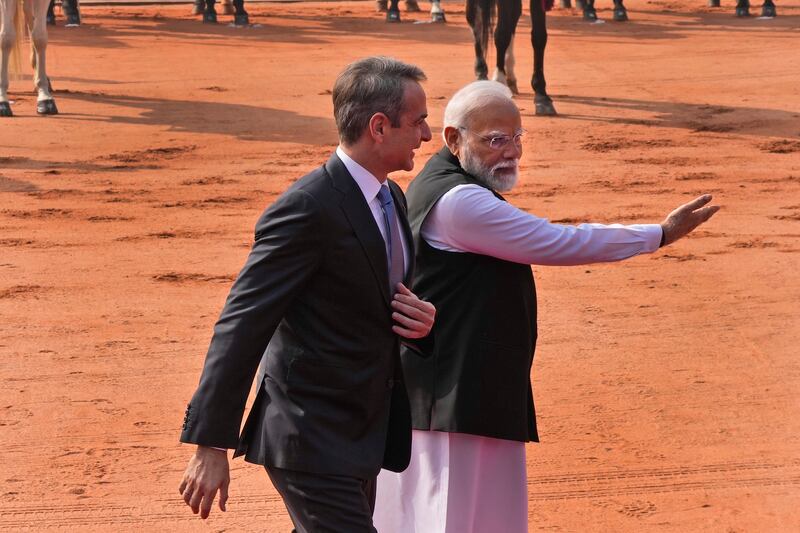 Indian Prime Minister Narendra Modi, right, gestures to Greek Prime Minister Kyriakos Mitsotakis during a ceremonial reception at the Indian presidential palace in New Delhi (Manish Swarup/AP)