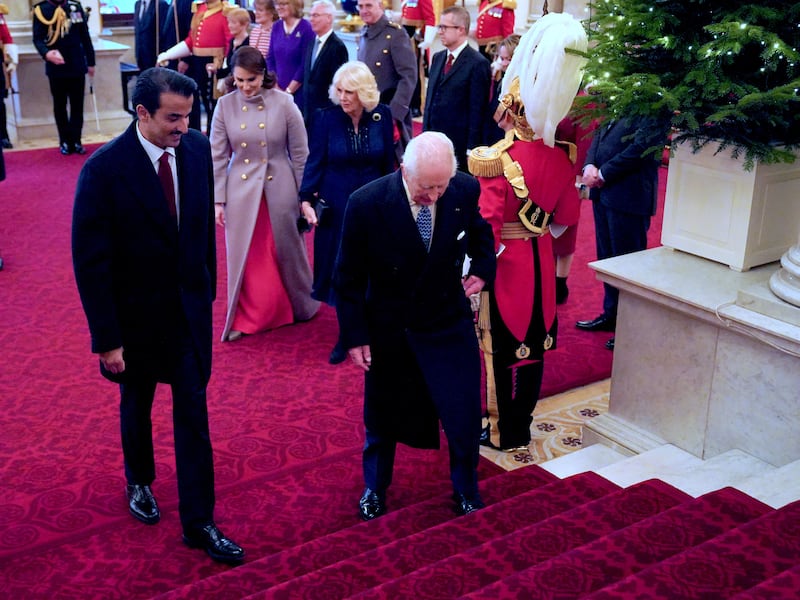 The King and Queen walk with the Emir of Qatar Sheikh Tamim bin Hamad Al Thani and his wife Sheikha Jawaher, at Buckingham Palace