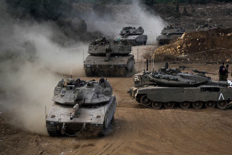 Israeli army tanks manoeuvre in a staging area in northern Israel near the Israel-Lebanon border (AP Photo/Baz Ratner)