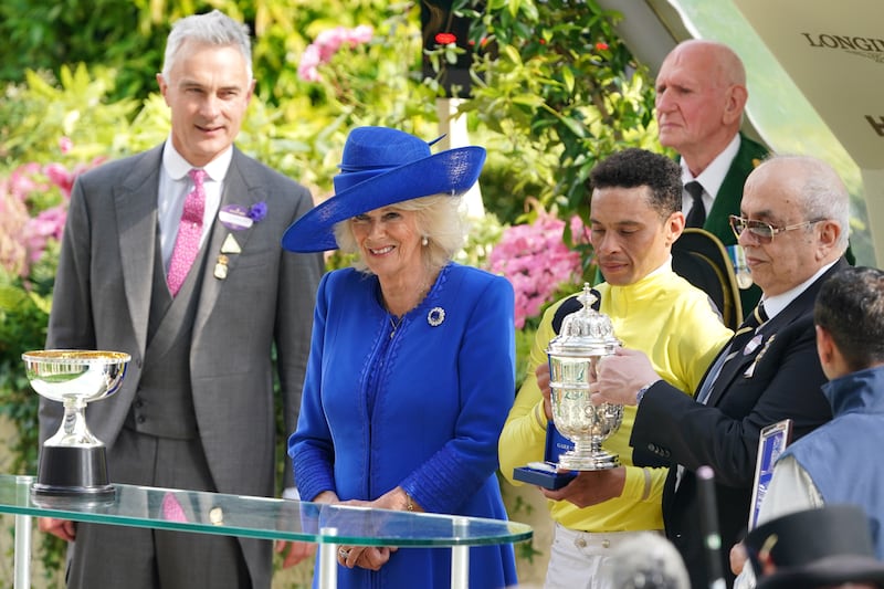 The Queen presents a trophy to winning jockey Sean Levey following the St James’s Palace Stakes on day one of Royal Ascot