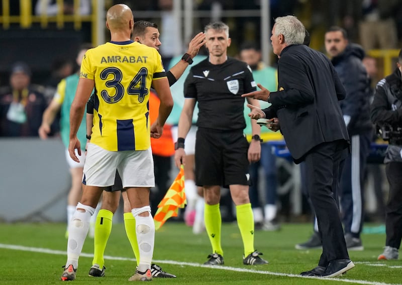 Fenerbahce head coach Jose Mourinho, right, argues with the referee