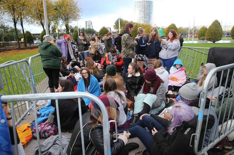 One Direction fans queuing outside the SSE Arena, Belfast yesterday were delighted the gigs were going ahead. Picture by Hugh Russell 