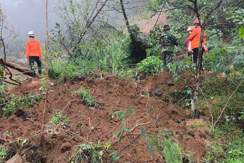 Rescuers search for victims of flash floods which triggered a landslide in Pekalongan, Central Java, Indonesia (BNPB via AP)