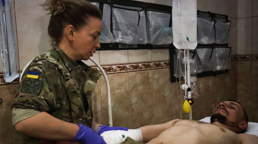 Military medics give first aid to wounded Ukrainian soldiers at a medical stabilisation point near Bakhmut, Donetsk region, Ukraine (Roman Chop via AP)