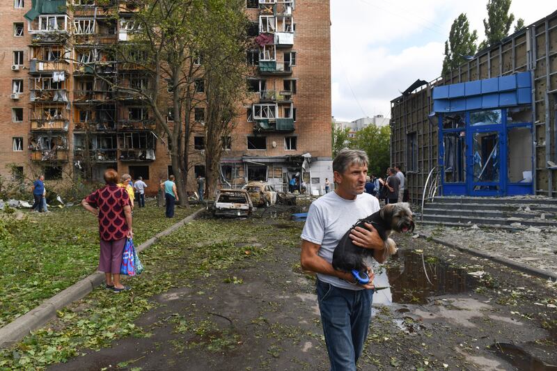 Residents of an apartment building damaged by Ukrainian shelling leave the area in Kursk, Russia (AP)