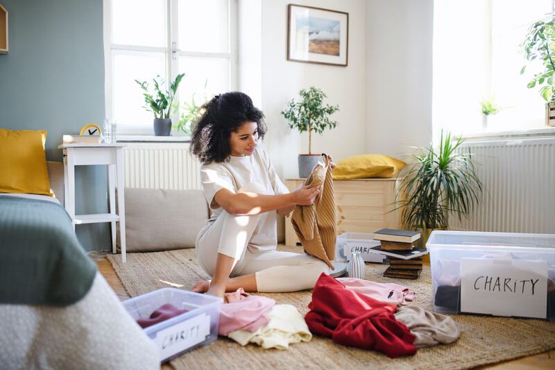 woman clearing out wardrobe