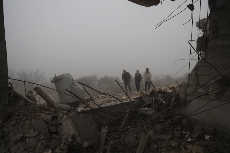 Syrians inspect the damage to an abandoned medical facility in the village of Talteta that was hit by Iranian missiles (Omar Albam/AP)