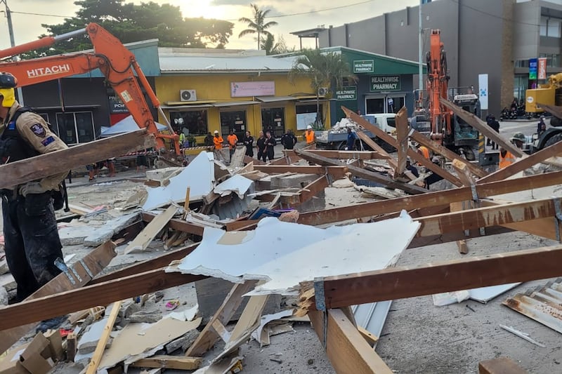 Australian rescue workers inspect a damaged building in Port Vila, Vanuatu, in December, following the earthquake (DFAT via AP)