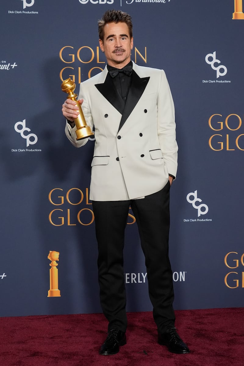 Colin Farrell poses in the press room with his award (Chris Pizzello/AP)