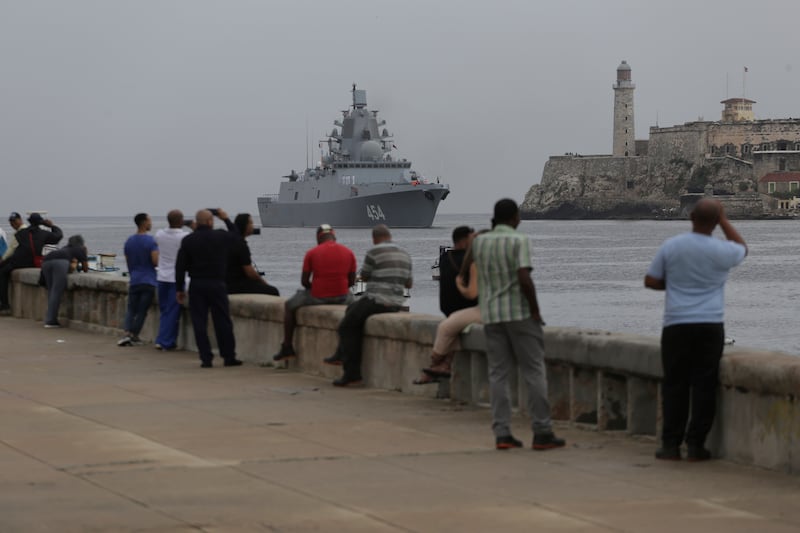 People watch a Russian navy frigate arrive at the port of Havana (Ariel Ley/AP)