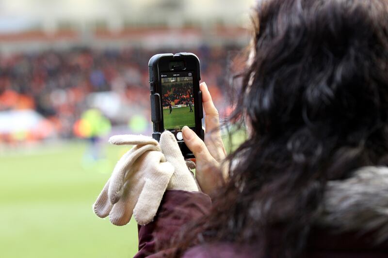 A woman taking a photo.