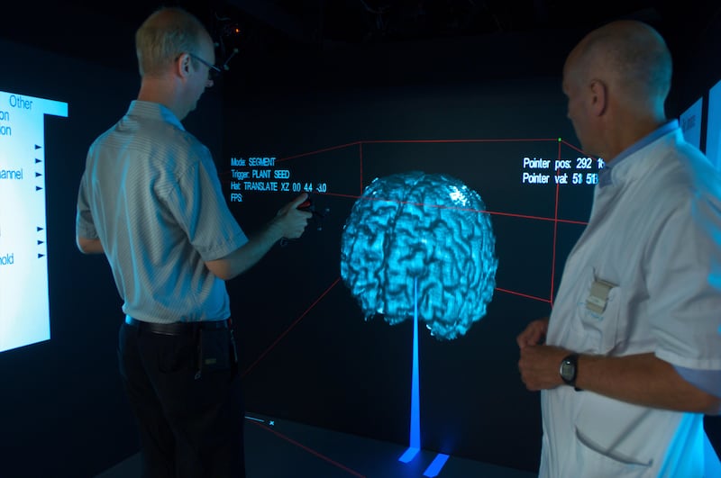 Technician helping a medical specialist with a virtual brain research calibration who is doing research on Alzheimer’s Disease