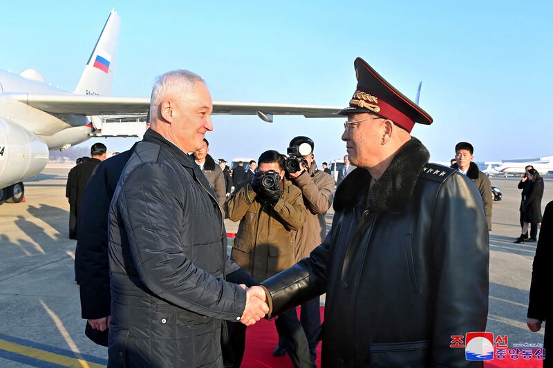 Russian defence minister Andrei Belousov shakes hands with North Korean defence minister No Kwang Chol on his arrival at a Pyongyang airport (Korean Central News Agency/Korea News Service via AP)