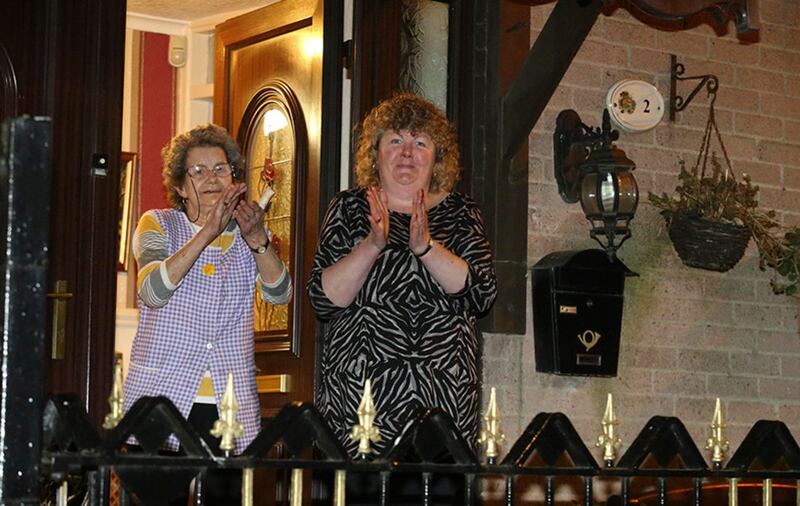 People in Belfast taking part in applauding carers and NHS workers last night. Picture by Hugh Russell&nbsp;