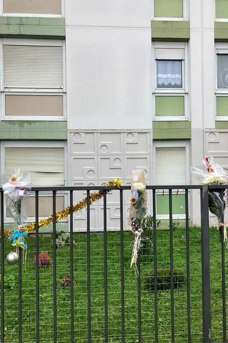 Flowers at the building’s gate (Nicolas Garriga/AP)