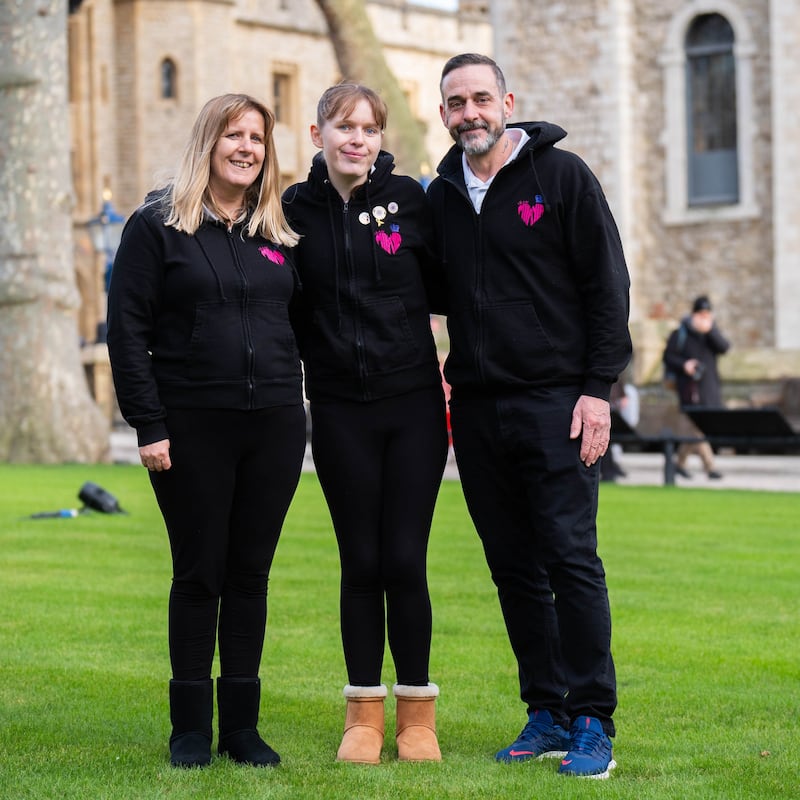 Mikayla Beames (centre) alongside her parents Natasha and Ian