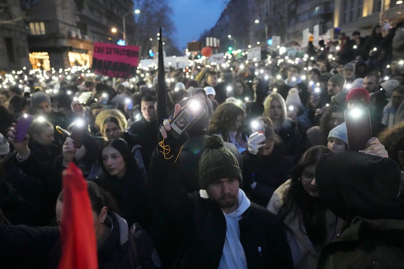 People gather in front of Serbia’s Constitutional Court building during an earlier protest over the collapse of a concrete canopy that killed 15 people (Darko Vojinovic/AP)