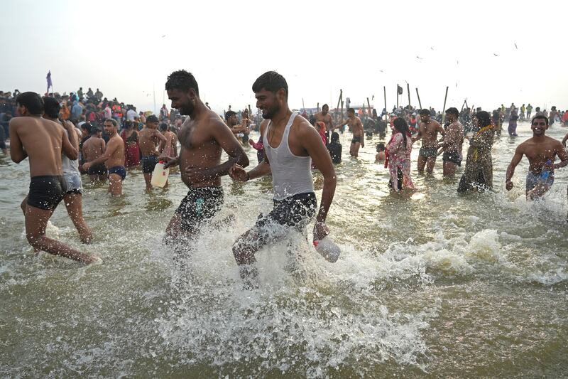 Hindu devotees take a holy dip in the Sangam in a bid to cleanse past sins (AP)