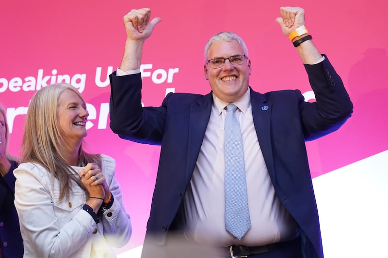 DUP leader Gavin Robinson raises his arms after speaking during the party’s annual conference at Crowne Plaza Hotel in Belfast