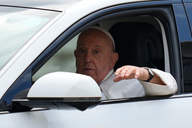 Pope Francis waves from the car, as he leaves from the Parliament House in Singapore (Vincent Thian/AP)