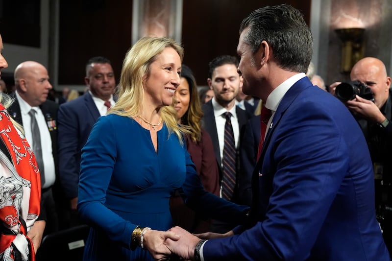 Jennifer Rauchet hugs her husband Pete Hegseth after his Senate Armed Services Committee confirmation hearing (Alex Brandon/AP)