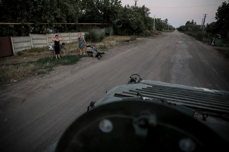 Residents cheer Ukrainian soldiers near Chasiv Yar town, in Donetsk (Oleg Petrasiuk/Ukrainian 24th Mechanised Brigade via AP)