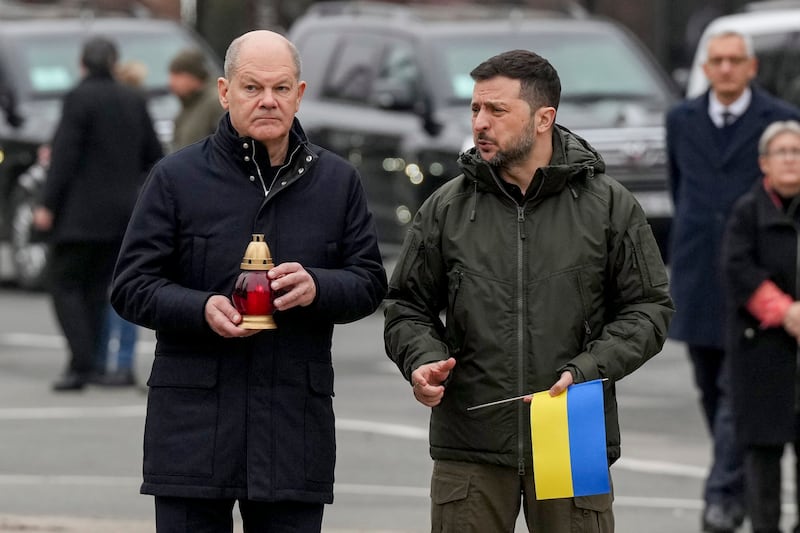 Ukraine’s President Volodymyr Zelenskyy, right, and German Chancellor Olaf Scholz attend a ceremony honouring fallen soldiers near the People’s Memorial of National Memory in Kyiv, Ukraine (Evgeniy Maloletka/AP)